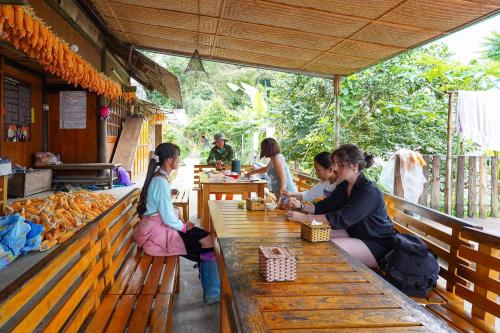 a group of people sitting at a table in a restaurant at Sapa Fantasea Homestay in Sapa