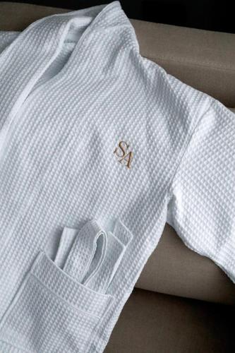 a white shirt with a pair of scissors on it at SAVOIE Apartments Bukovel in Bukovel