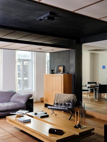 a living room with a couch and a table at CE RESIDENCE in Ghent
