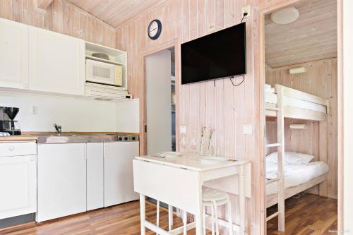 a small kitchen with a desk and a bunk bed at First Camp Torekov-Båstad in Torekov