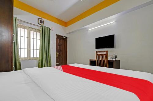 a bedroom with a bed and a desk and a television at Hotel Signature Cochin in Cochin