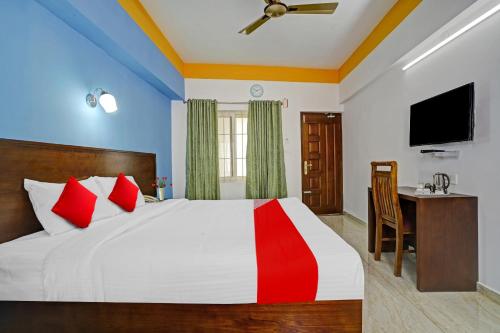 a bedroom with a bed and a desk and a television at Hotel Signature Cochin in Cochin