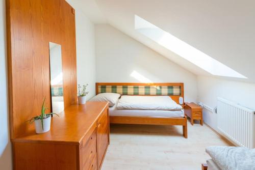 a bedroom with a bed and a dresser in a room at Na Helštýně in Frenštát pod Radhoštěm