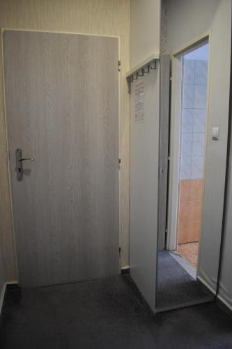 an empty hallway with a door and a mirror at Hotel Boršičanka in Havířov