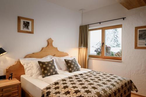 a bedroom with a large bed and a window at Vila Pavlina in Kranjska Gora