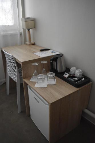 a wooden desk with a coffee maker on it at Hotel Boršičanka in Havířov