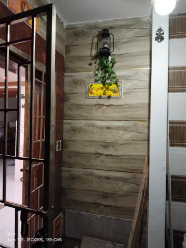 a stairwell with a wooden wall with a plant at MEGA HOME in Bhubaneshwar