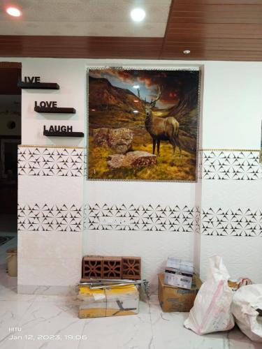 a painting of a deer on a wall at MEGA HOME in Bhubaneshwar