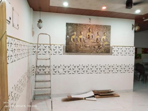 a room with a ladder and a painting on the wall at MEGA HOME in Bhubaneshwar