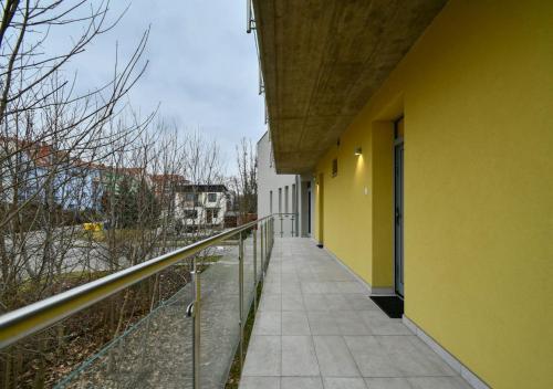 a balcony of a building with a yellow wall at EFI Residence Holzova 28 in Brno