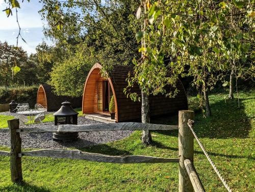 a wooden fence in front of a tiny house at Glamping at Honnington Farm in Royal Tunbridge Wells