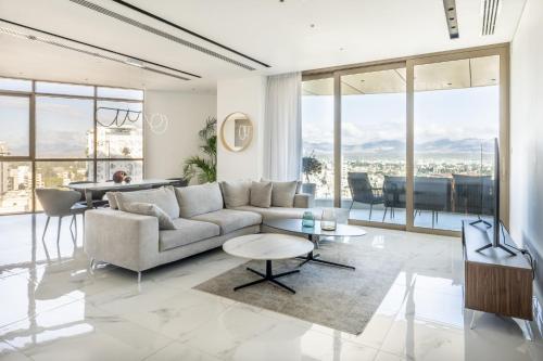 a living room with a couch and a table at 360 Nicosia - Luxury Apartment Panoramic View in Nicosia