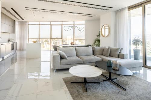 a living room with a couch and a table at 360 Nicosia - Luxury Apartment Panoramic View in Nicosia