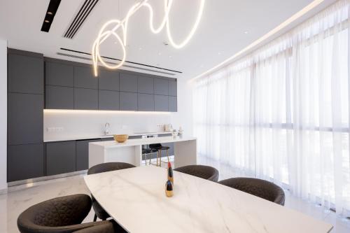 a kitchen with a white table and chairs at 360 Nicosia - Luxury Apartment Panoramic View in Nicosia