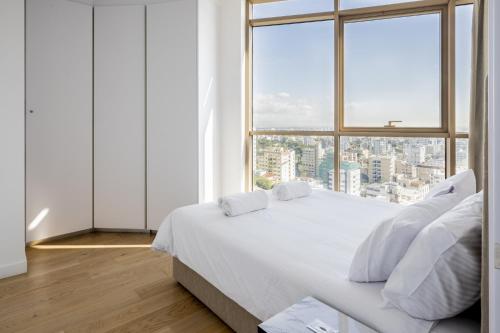 a bedroom with a white bed and a large window at 360 Nicosia - Luxury Apartment Panoramic View in Nicosia