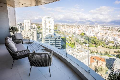 a balcony with chairs and a view of a city at 360 Nicosia - Luxury Apartment Panoramic View in Nicosia