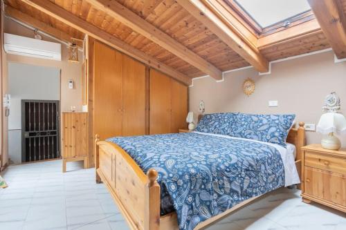 a bedroom with a wooden bed and a skylight at Lo chalet di Giulia - Romantic terrace in Bologna