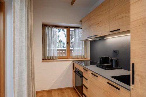 a kitchen with wooden cabinets and a counter top at Vila Pavlina in Kranjska Gora
