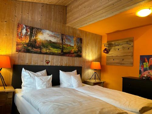 a bedroom with a large bed with white pillows at Maier Pension in Bayerisch Eisenstein