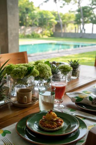 a table with a plate of food on top of it at Tranquil Waters in Negombo