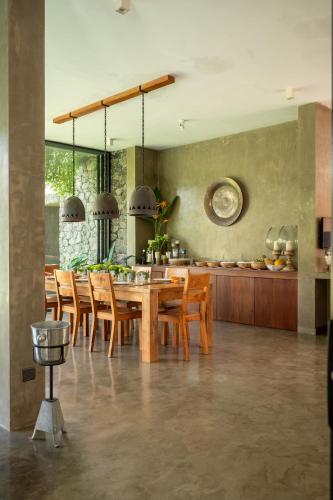 a dining room with a wooden table and chairs at Tranquil Waters in Negombo
