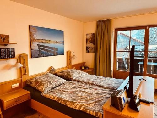 a hotel room with a bed and a window at Ferienwohnung Fuchs in Pfronten