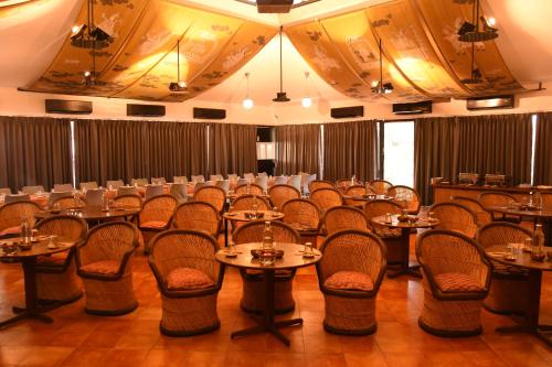 a large room with tables and chairs in it at The House of MG-A Heritage Hotel, Ahmedabad in Ahmedabad