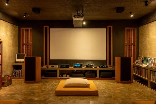 a large screen in a living room with a bed at Tranquil Waters in Negombo