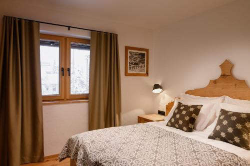 a bedroom with a bed and a window at Vila Pavlina in Kranjska Gora