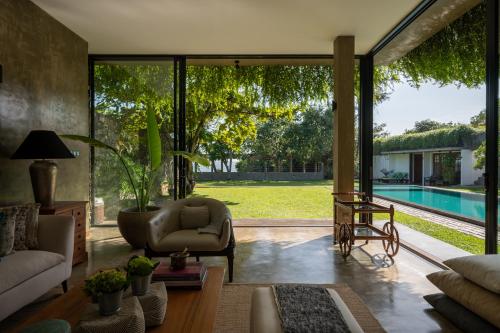 a living room with a view of a pool at Tranquil Waters in Negombo