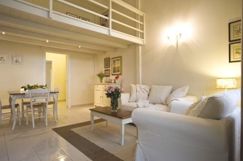 a living room with a white couch and a table at Cevoli Country Resort in Lari