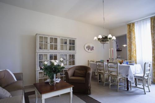 a living room with a table and a dining room at Cevoli Country Resort in Lari