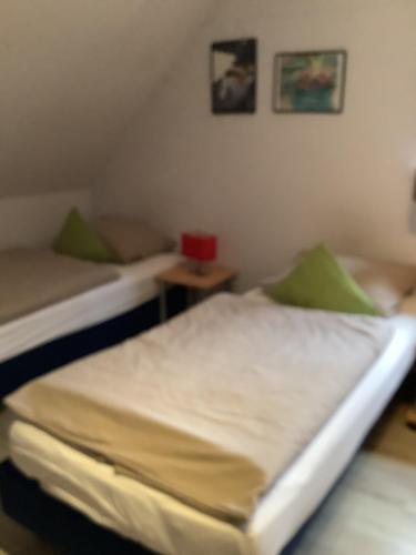 a bedroom with two beds and a table at FEWO Appartement 5 in Minden