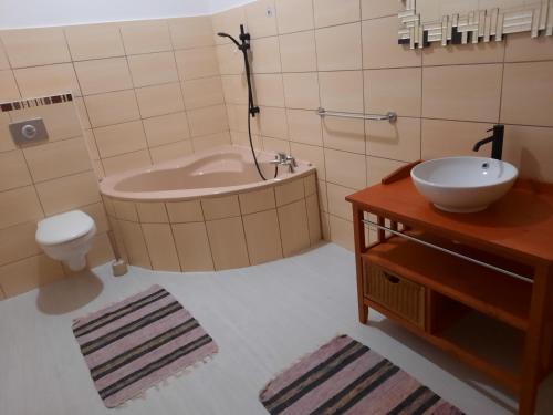 a bathroom with a tub and a sink and a toilet at Château Japy F3 7 ieme art 