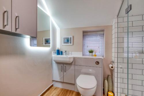 a bathroom with a toilet and a sink at The Station Loft City Centre 1-Bed Apartment in Worcester