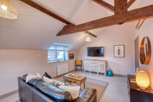 a living room with a couch and a table at The Station Loft City Centre 1-Bed Apartment in Worcester