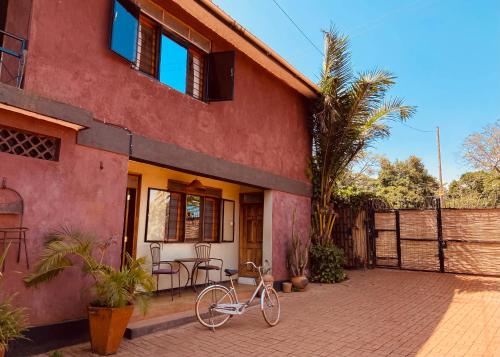 a bike is parked outside of a house at HomeOnTheNile Lake view double in Jinja