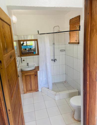 a bathroom with a toilet and a shower and a sink at HomeOnTheNile Lake view double in Jinja