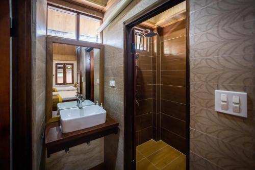a bathroom with a sink and a mirror at Villa Mira Heritage in Luang Prabang