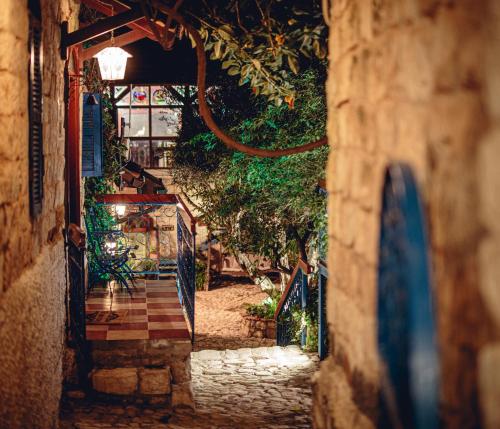an alley with a gate and a stone path at וילה תהילה המחודש - The new Villa Tehila in Rosh Pinna