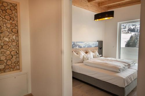 a bedroom with a bed and a large window at Apartment Victoria in Gries am Brenner