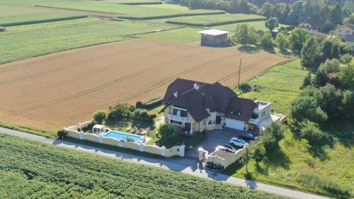an aerial view of a large house in a field at Appartements Panorama Schlössl in Velden am Wörthersee