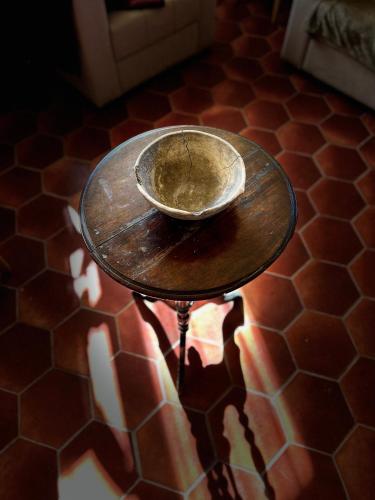 a bowl sitting on a table on a floor at Saryan Guesthouse in Goris