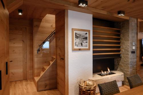 a living room with a staircase and a fireplace at Vila Pavlina in Kranjska Gora