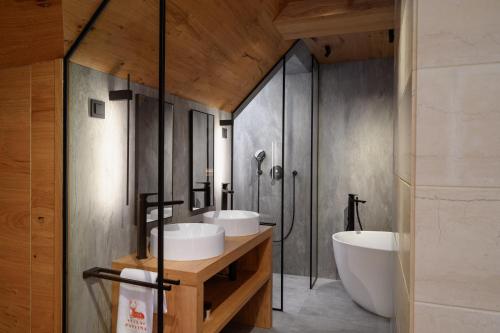 a bathroom with two sinks and a tub at Vila Pavlina in Kranjska Gora