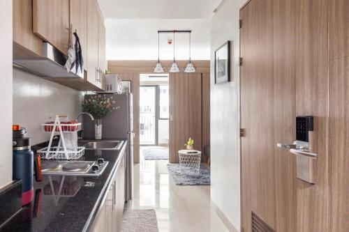 a kitchen with a sink and a stove top oven at Shore 2 Apartment with Balcony in Manila