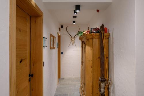 a hallway with a wooden cabinet in a room at Vila Pavlina in Kranjska Gora
