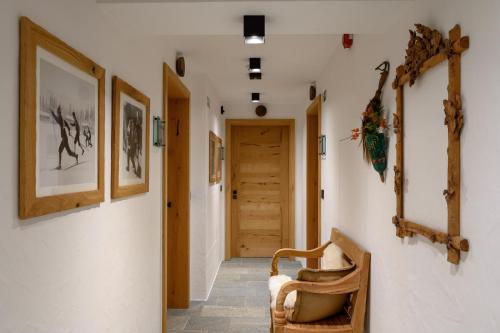 a hallway with a chair and a wooden door at Vila Pavlina in Kranjska Gora