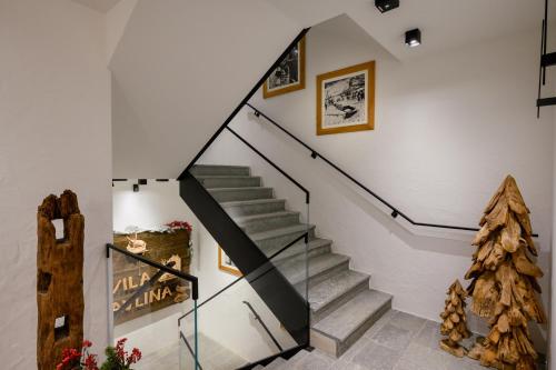 a staircase in a house with a christmas tree at Vila Pavlina in Kranjska Gora