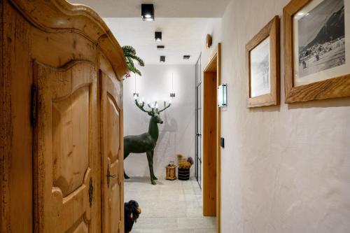 a hallway with a statue of a deer in a room at Vila Pavlina in Kranjska Gora